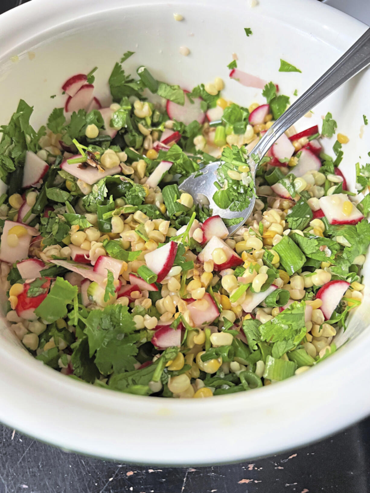 Roasted chicken thigh teams up with a crisp and zesty corn salad for a quick and easy weeknight meal.