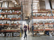 Warehouse Manager Lucas Salazr, left, and warehouse worker Chase Campbell, right, fill orders at Vancouver Bolt & Supply in 2019.  Demand for warehouse space like this supply company's have increased in recent years.