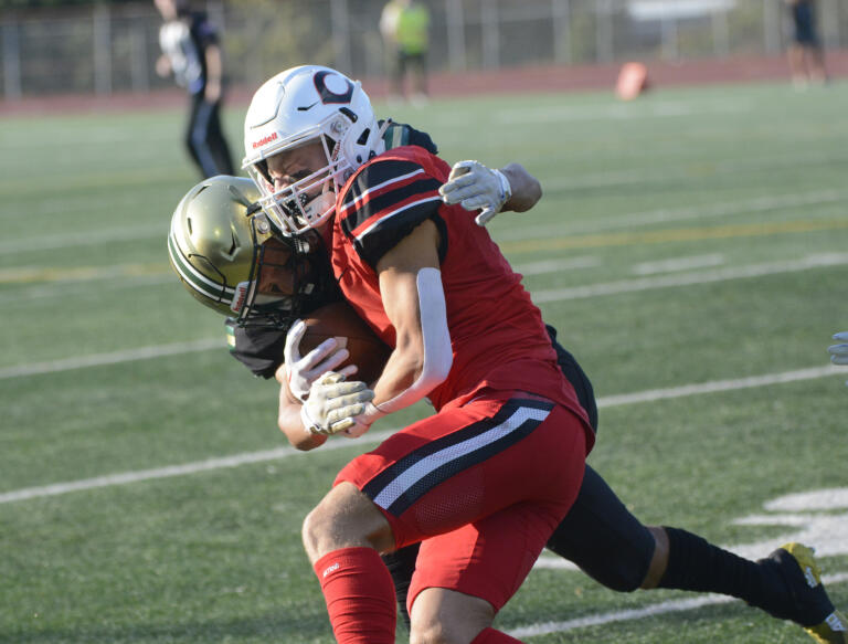 Evergreen’s Josiah Alanis puts a hit on Camas’ Konnoer Limnell during Camas’ 42-14 win over Evergreen at McKenzie Stadium on Friday, Oct. 7, 2022.