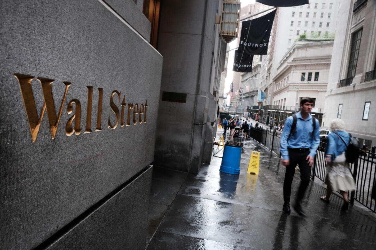 People walk by the New York Stock Exchange on June 14, 2022, in New York.