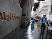 People walk by the New York Stock Exchange on June 14, 2022, in New York.