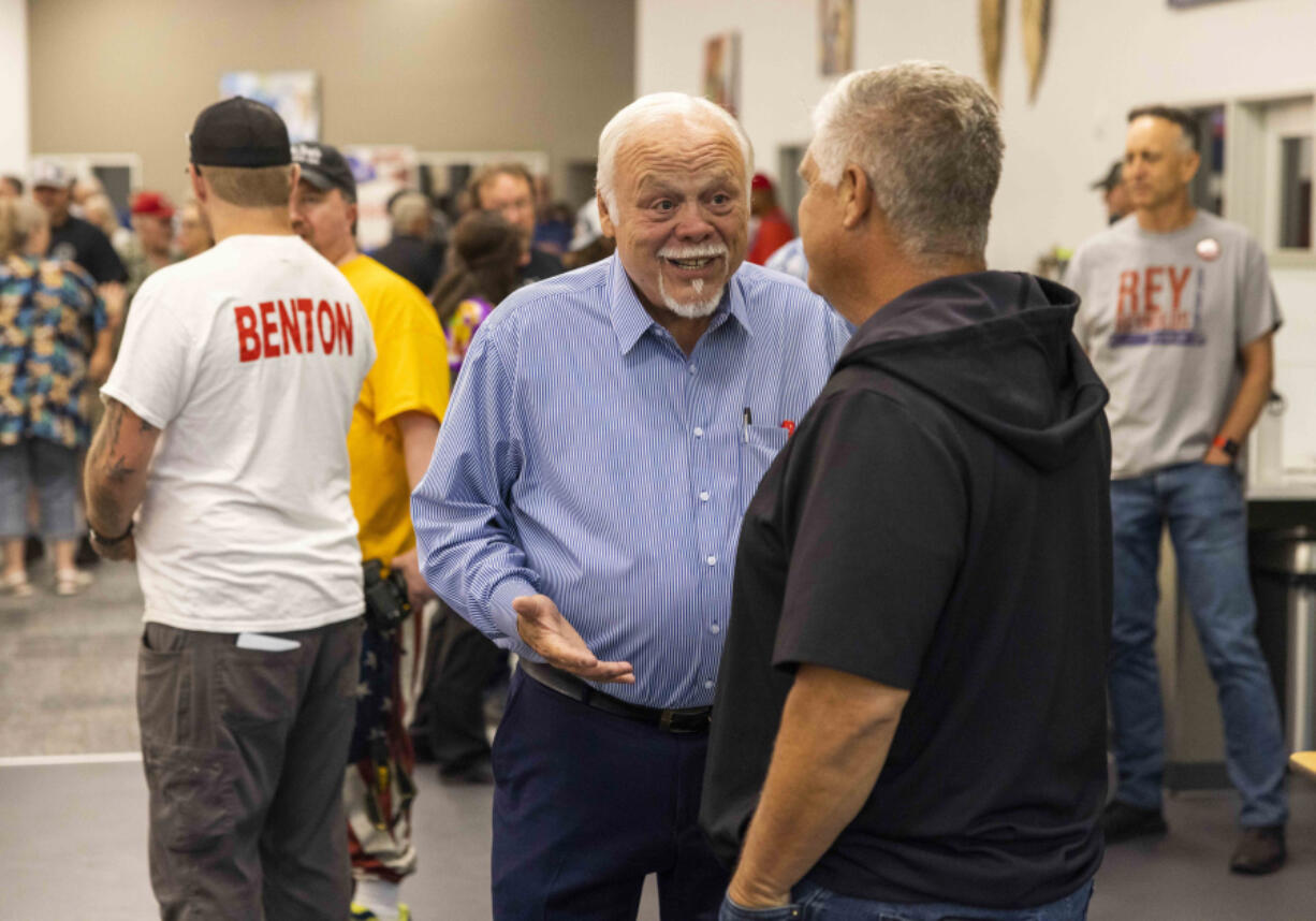 Don Benton, center, talks to a visitor at the RV Inn Style Resort Convention Center on Sept. 8, 2022. Benton, who has served as a member of the Washington House of Representatives and Washington State Senate, is running for Clark County Council District 5 seat.