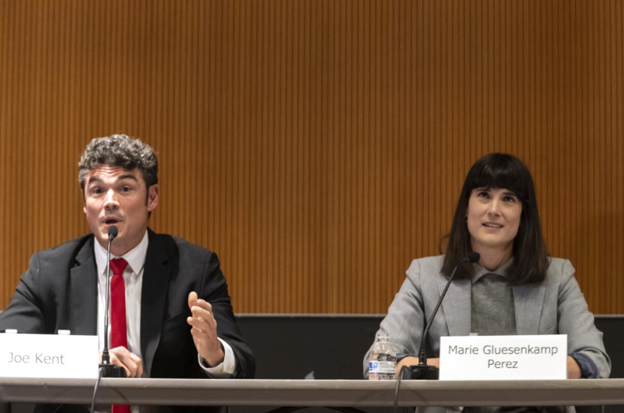 Democratic candidate for Washington's 3rd Congressional District Marie Gluesenkamp Perez, right, looks skyward while Republican candidate Joe Kent gives his closing remarks on Saturday during a debate at the Vancouver Community Library.