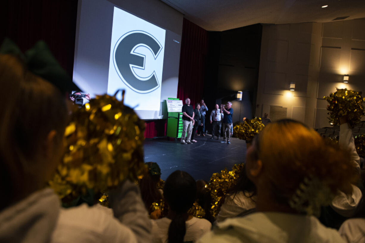 Students, including Evergreen High School cheerleaders, honor teacher Bill Culver as he takes center stage during an award ceremony on Tuesday morning. Culver, who teaches construction at Evergreen High School, is one of five grand prize recipients of the 2022 Harbor Freight Tools for Schools Prize for Teaching Excellence. The award comes with a $100,000 grant to Culver and his school.