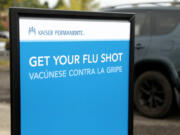 A sign urges people to get a flu shot at Kaiser Permanente.