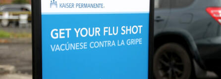 A sign urges people to get a flu shot at Kaiser Permanente.