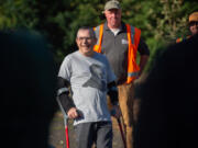 Paul Danzer, a longtime local sports reporter, listens as colleagues and friends extol his virtues during a tree-planting ceremony dedicated to him at Biddlewood Park in Vancouver.