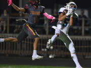 Mountain View senior Jacob Martin, right, catches a long touchdown Friday, Oct. 7, 2022, during a game between Prairie and Mountain View at District Stadium in Battle Ground.