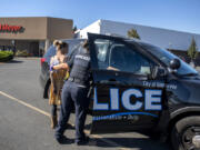 Vancouver police Officer Andrea Mendoza escorts a suspected shoplifter into a patrol car Wednesday at the Fred Meyer store in Cascade Park. The woman was booked into the Clark County Jail on suspicion of third-degree theft and later released. The agency says this is a growing problem and has begun patrol shifts emphasizing retail theft.