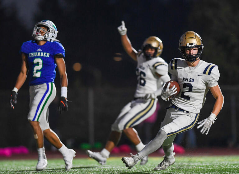 Kelso senior Naiser Lukas, center, celebrates after teammate Zeke Smith, right, intercepts a pass meant for Mountain View junior Akili Kamau on Thursday, Oct. 13, 2022, during the Hilanders’ 28-26 win against Mountain View at McKenzie Stadium.