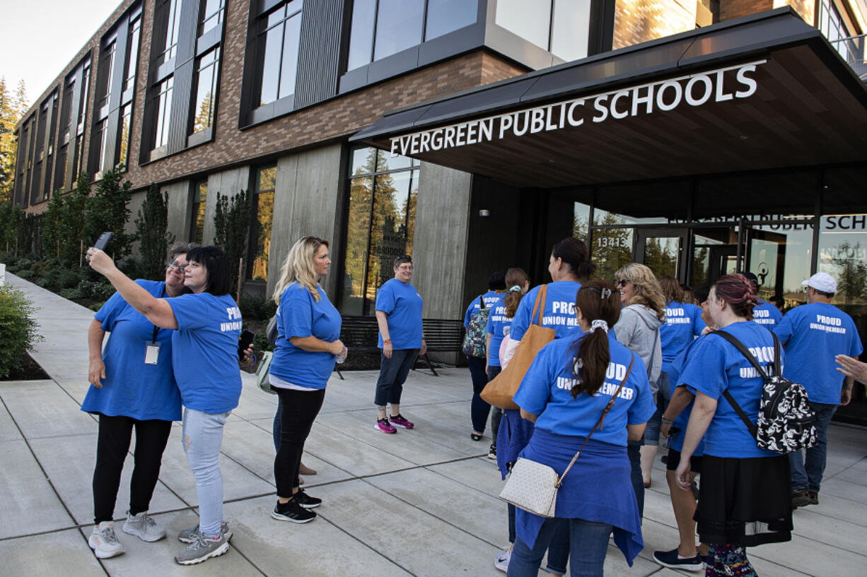 Members of the Evergreen Public School Employees large group union, also known as PSE #1948 make their way into Evergreen Public Schools headquarters on Tuesday afternoon. The union represents about 1,000 employees in the district.