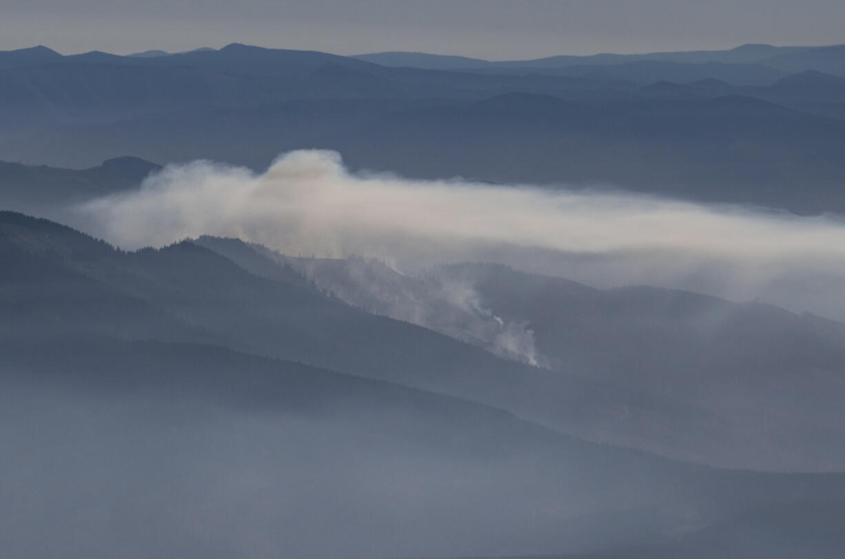 The Nakia Creek Fire burns Tuesday near Larch Mountain in Clark County. The fire is still at approximately 156 acres and crews continue to work on reinforcing fire lines, according to the Clark Regional Emergency Services Agency website.