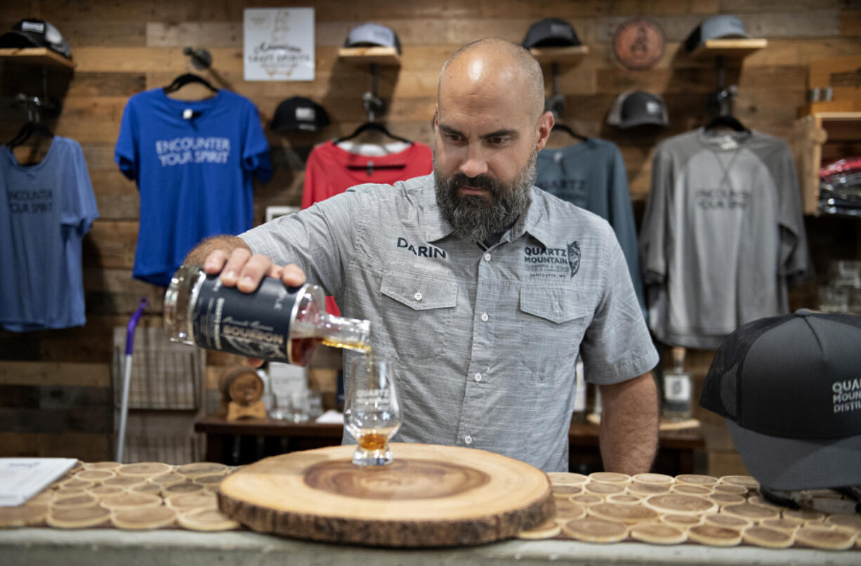 Darin Kyle of Quartz Mountain Distillers pours a sample of bourbon while taking a break at his Vancouver-area distillery earlier this month.