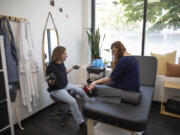 Shonna Roberts of Omnis Ink tattoos over 20-year-old self-harm scars for Angie Williams, program manager at the National Alliance on Mental Illness, at her downtown Vancouver studio. Omnis Ink, Vancouver's first advanced paramedical tattooing studio, recently began working with the National Alliance on Mental Illness to provide scar camouflage treatment for self-harm scars.