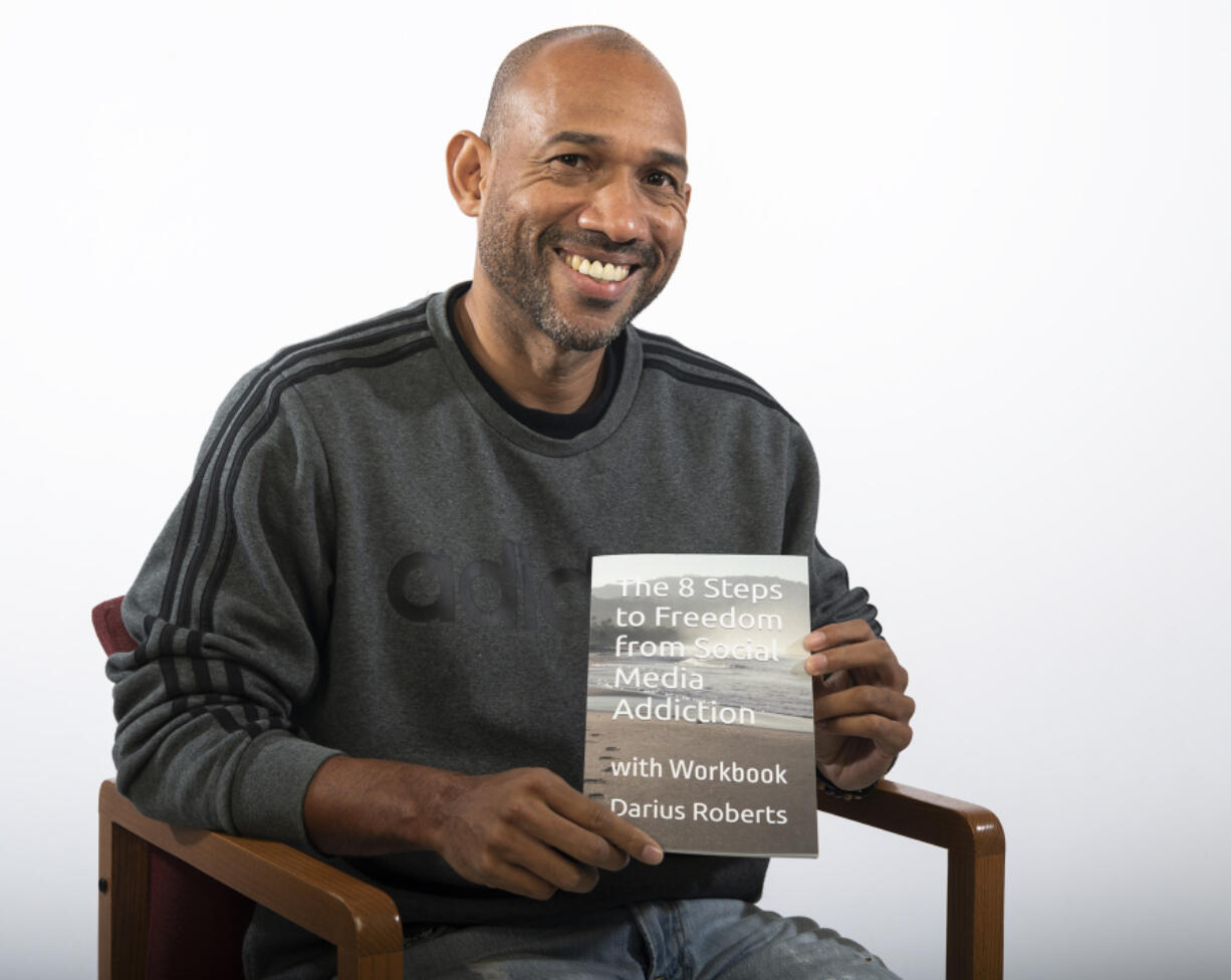 Darius Roberts poses with a copy of his first book, "The 8 Steps to Freedom from Social Media Addiction." Roberts, who grew up in Vancouver, said the inspiration for the book stemmed from his own experience finding himself attached to Facebook.