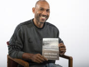 Darius Roberts poses with a copy of his first book, "The 8 Steps to Freedom from Social Media Addiction." Roberts, who grew up in Vancouver, said the inspiration for the book stemmed from his own experience finding himself attached to Facebook.