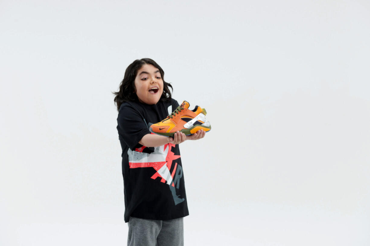 Dario Villaseñor Valdivia, a 14-year-old from Vancouver, holds the shoe he designed with Nike through the Doernbecher Freestyle program.