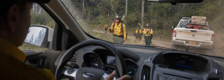 Marcus Kauffman of the Oregon Department of Forestry, left, passes fire crews as they work at the Nakia Fire on Wednesday afternoon, Oct. 19, 2022.