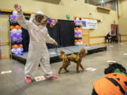 Bonita York, left, shows off Cassidy, a 1-year-old Irish doodle, on Thursday during a dog costume contest at the Battle Ground Community Center.