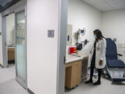 Dr. Terry Moy-Brown checks out one of the exam rooms at the new Vancouver Clinic urgent care center in Salmon Creek. Officials say they plan to open the facility Nov. 7.