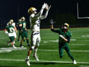 Kelso senior Zeke Smith, center, catches a pass Friday, Oct. 28, 2022, during a game between Kelso and Evergreen at McKenzie Stadium.