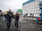 Gov. Jay Inslee, left, and his wife, Trudi, leave after joining a tour of the Fourth Plain Community Commons mixed-use building project on Monday morning, Oct. 31, 2022.