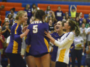 Columbia River players, from left, Logan DeJong, Lauren Dreves, Ellie Ogee and Sasha Pelkey celebrate a point in a Class 2A Greater St. Helens League volleyball match against Ridgefield on Thursday, Oct. 13, 2022 at Ridgefield High School.