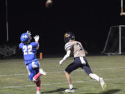 La Center's Levi Giles catches a touchdown pass ahead of Seton Catholic defender Max Ackerman on Friday, Oct. 14, 2022 at La Center High School.