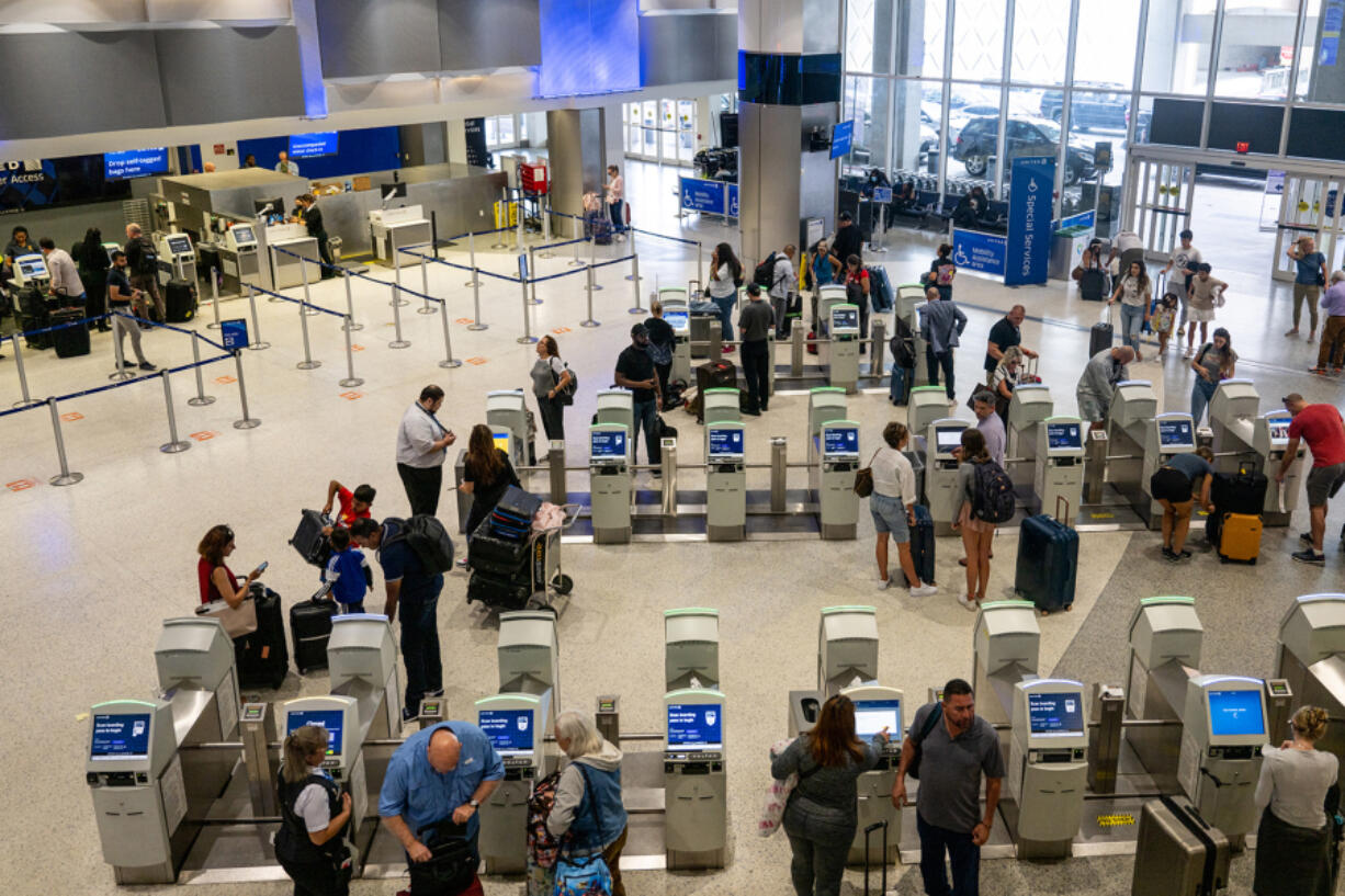 People check in for departure flights at the George Bush Intercontinental Airport on Sept. 2, 2022, in Houston, Texas.