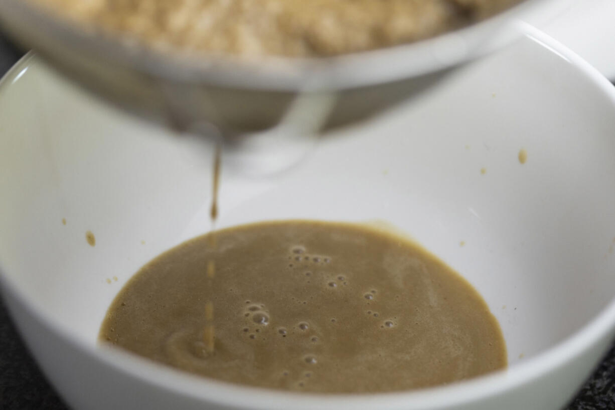 Susanna Foo begins to strain the flavor from the mushrooms to create a Porcini Mushroom and Truffle Sauce.