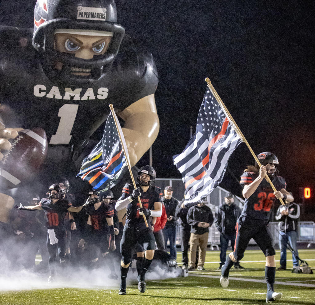 Camas players run out of the tunnel prior to the Papermakers' game against Union on Oct. 21, 2022, at Doc Harris Stadium.