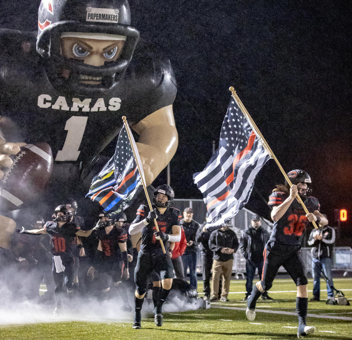 Camas players run out of the tunnel prior to the Papermakers' game against Union on Oct. 21, 2022, at Doc Harris Stadium.