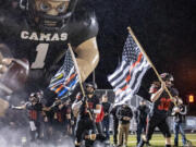 Camas players run out of the tunnel prior to the Papermakers' game against Union on Oct. 21, 2022, at Doc Harris Stadium.