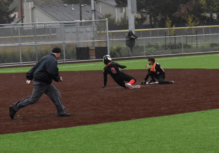 Battle Ground's Lorelei Brown forces out Union's Sophia Richard (6) as second base during the 4A district slowpitch softball playoff at Heritage High School on Friday, Oct. 21, 2022.