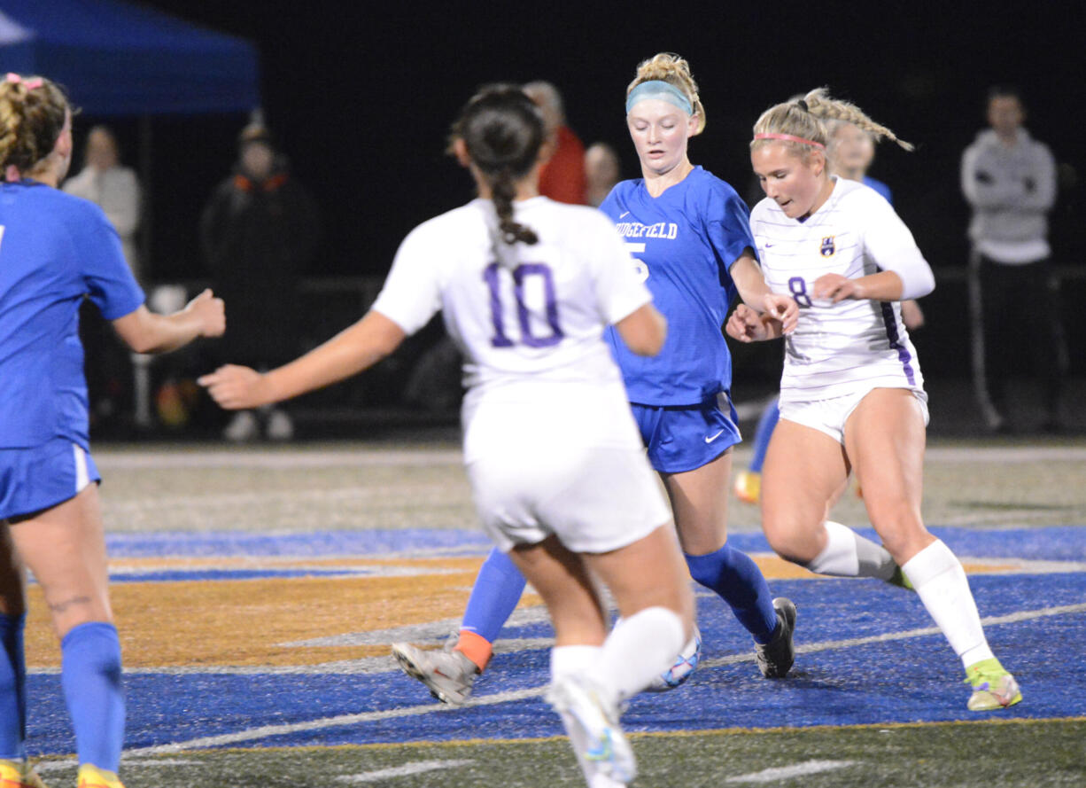 Ridgefield’s Ellie Petersen (5) and Columbia River’s Maree Seibel battle for possession of the ball during the first half on Oct. 26, 2022, at Ridgefield High School.