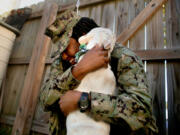 After being apart for over a year, Petty Officer 2nd Class Myesha Harris, who was deployed on the USS Harry S. Truman, and her 21/2-year-old male French bulldog Nipsey are reunited Oct. 14 in Deb Coon's backyard. (Stephen M.