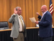 Washougal Mayor David Stuebe, right, administers the oath of office to newly appointed Washougal City Council member David Fritz at Washougal City Hall on Oct. 24.