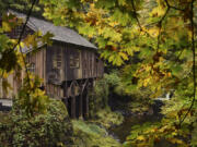 The Cedar Creek Grist Mill in Woodland is seen through changing autumn leaves in 2017. Low water levels in Cedar Creek have forced the cancellation of the annual apple cider pressing event this weekend.