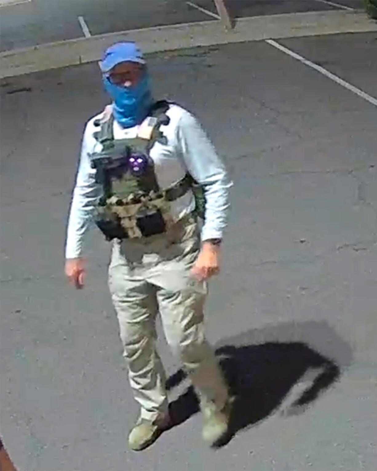 An armed individual dressed in tactical gear at a ballot drop box in Mesa, Arizona, on Oct. 21, 20221.