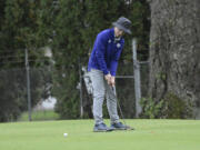 Columbia River’s Noah Larson putts on the No. 5 green at Orchard Hills Golf Club in Washougal during a playoff at the Class 2A District 4 golf tournament on Tuesday, Oct.