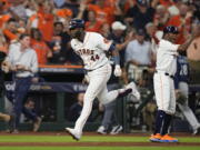 Houston Astros designated hitter Yordan Alvarez (44) celebrates with teammates after his three-run, walkoff home run against the Seattle Mariners during the ninth inning in Game 1 of an American League Division Series baseball game in Houston,Tuesday, Oct. 11, 2022. (AP Photo/David J.