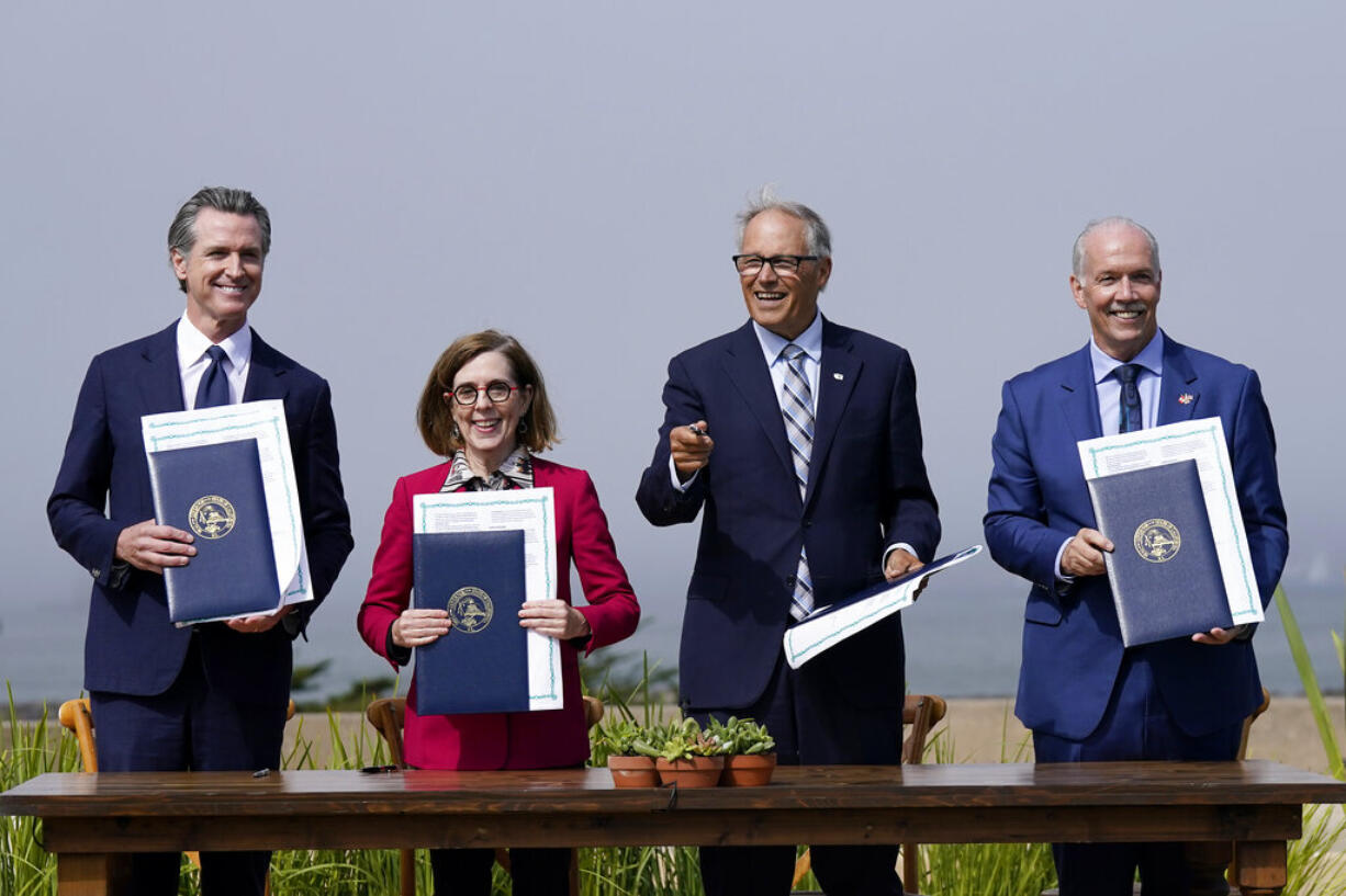 California Governor Gavin Newsom, from left, poses for photos after signing a new climate agreement with Oregon Governor Kate Brown, Washington Governor Jay Inslee and British Columbia Premier John Horgan at the Presidio Tunnel Tops in San Francisco, Thursday, Oct. 6, 2022.