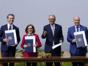 California Governor Gavin Newsom, from left, poses for photos after signing a new climate agreement with Oregon Governor Kate Brown, Washington Governor Jay Inslee and British Columbia Premier John Horgan at the Presidio Tunnel Tops in San Francisco, Thursday, Oct. 6, 2022.