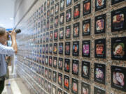 FILE—A photojournalist takes pictures of the exhibits on "The Faces of Fentanyl" at DEA headquarters before a press event at DEA headquarters, Arlington, Va., in this file photo from Sept. 27, 2022. Heading into key elections, there have been assertions that the drug might be handed out like Halloween candy, something the U.S. Drug Enforcement Agency's head has said isn't true.