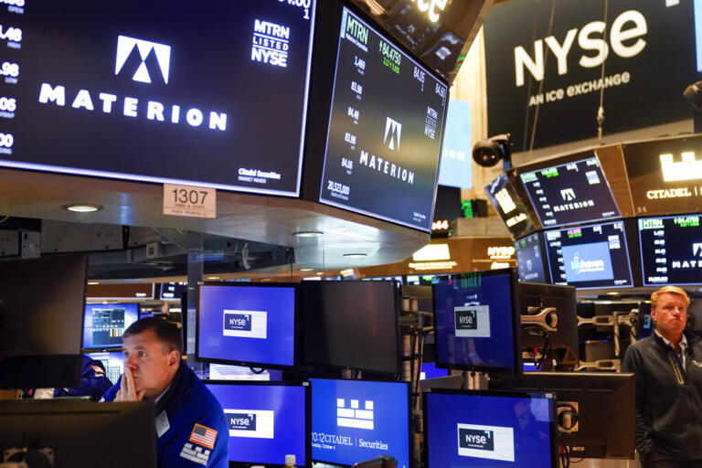 Traders work on the floor at the New York Stock Exchange in New York, Tuesday, Oct. 4, 2022. Stocks are opening lower on Wall Street, but with one day left in October major indexes are still headed for big gains for the month. Investors this week will be watching for another extra-large interest rate increase from the Federal Reserve, part of the central bank's fight against inflation, and the government's monthly report on the job market.