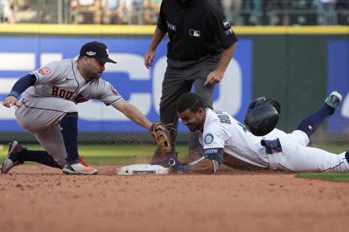 Seattle Mariners' Julio Rodriguez (44) slides safely into second base for a double under Houston Astros second baseman Jose Altuve during the eighth inning in Game 3 of an American League Division Series baseball game Saturday, Oct. 15, 2022, in Seattle. (AP Photo/Ted S.