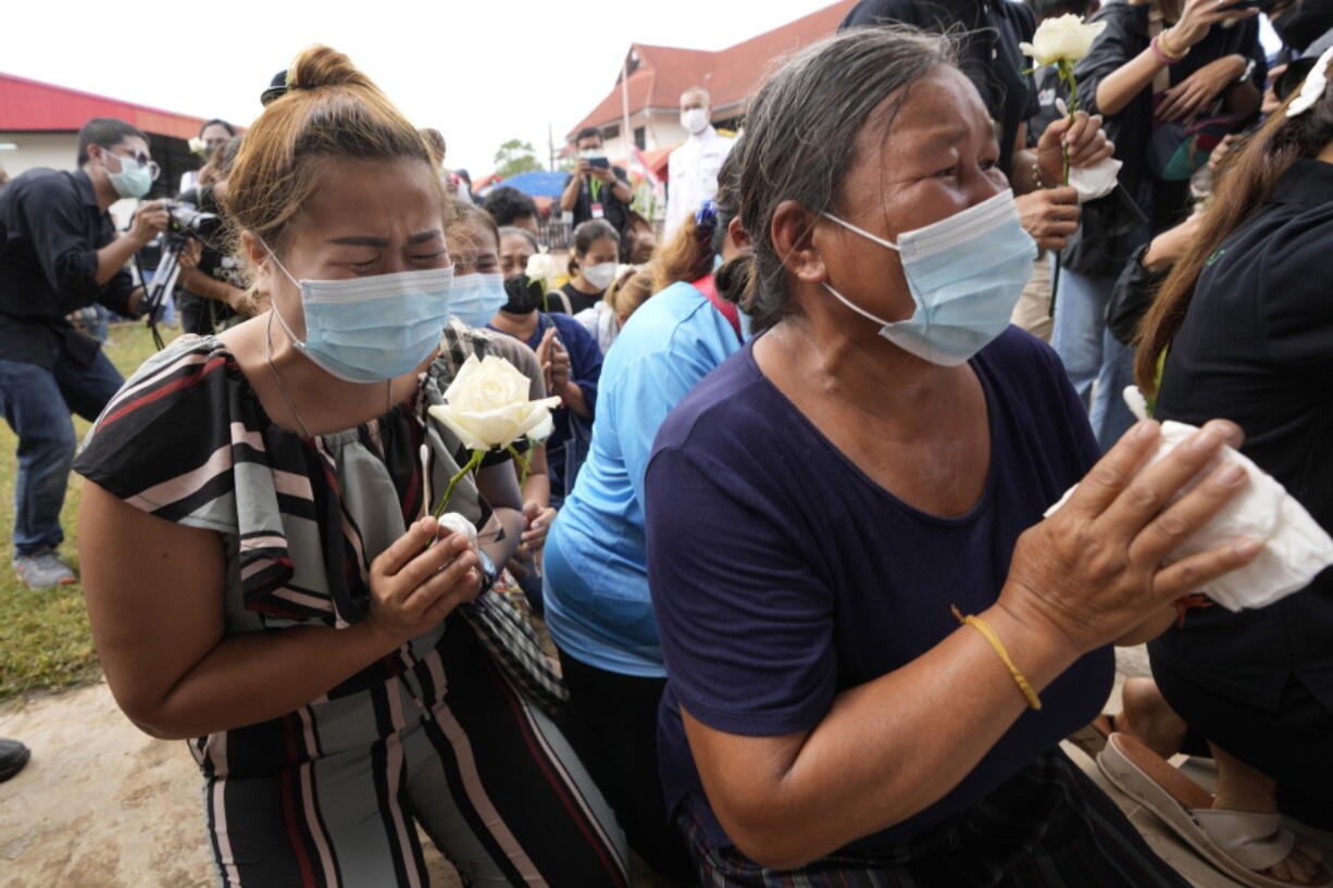 Relatives pray during a ceremony for those killed in the attack on the Young Children's Development Center in the rural town of Uthai Sawan, north eastern Thailand, Friday, Oct. 7, 2022. A former policeman facing a drug charge burst into a day care center in northeastern Thailand on Thursday, killing dozens of preschoolers and teachers before shooting more people as he fled in the deadliest rampage in the nation's history.