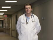 Dr. Connor McNamee, a third-year family medicine resident at the University of Toledo Medical Center, poses at the medical center, Tuesday, Oct. 18, 2022, in Toledo, Ohio. Students in obstetrics-gynecology and family medicine are facing tough choices about where to advance their training in a landscape where legal access to abortion varies from state to state. McNamee began exploring abortion training outside Ohio last summer. A state law bans most abortions after cardiac activity is detected, but a judge has blocked it while a challenge proceeds.