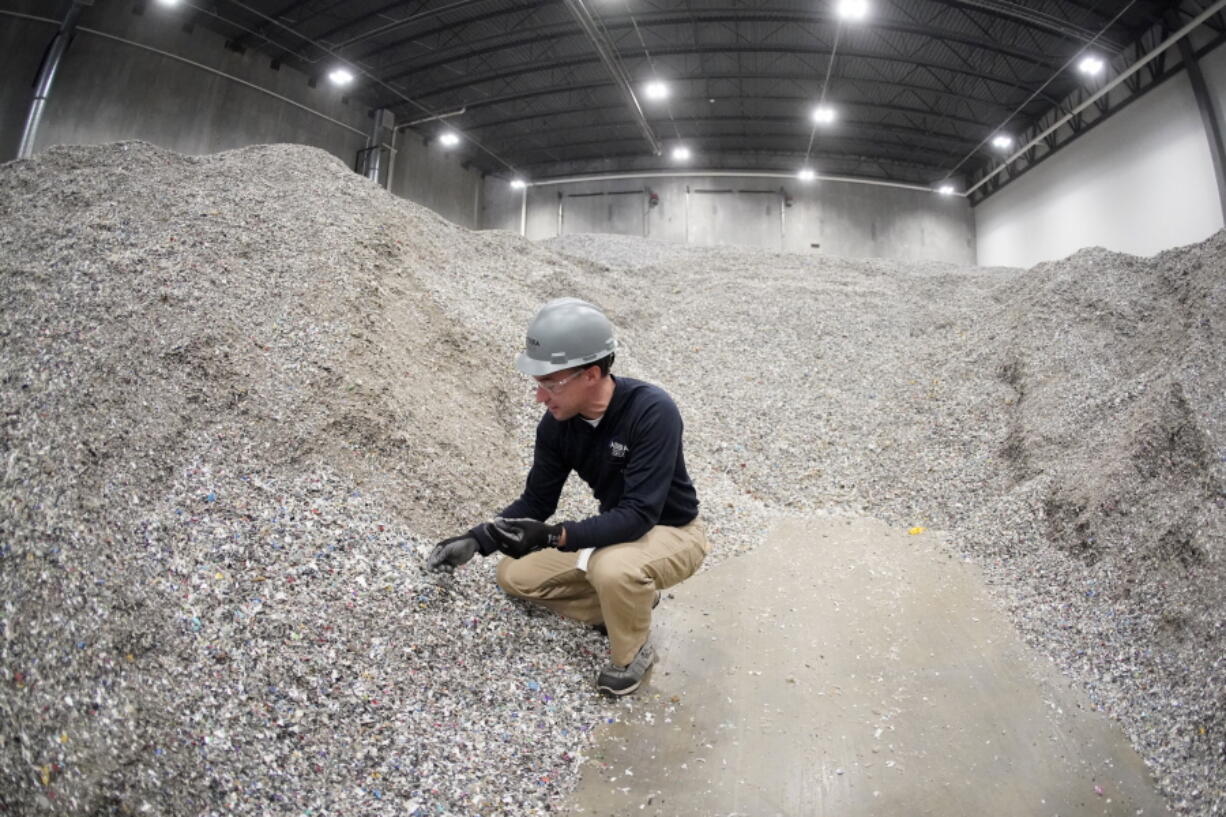 Jeremy DeBenedictis, President of Alterra Energy, stands in the storage area of shredded plastics his company receives from recycling facilities in their facility in Akron, Ohio, on Thursday, Sept. 8, 2022. "Our mission is to solve plastic pollution," said DeBenedictis, company president. "That is not just a tag line.