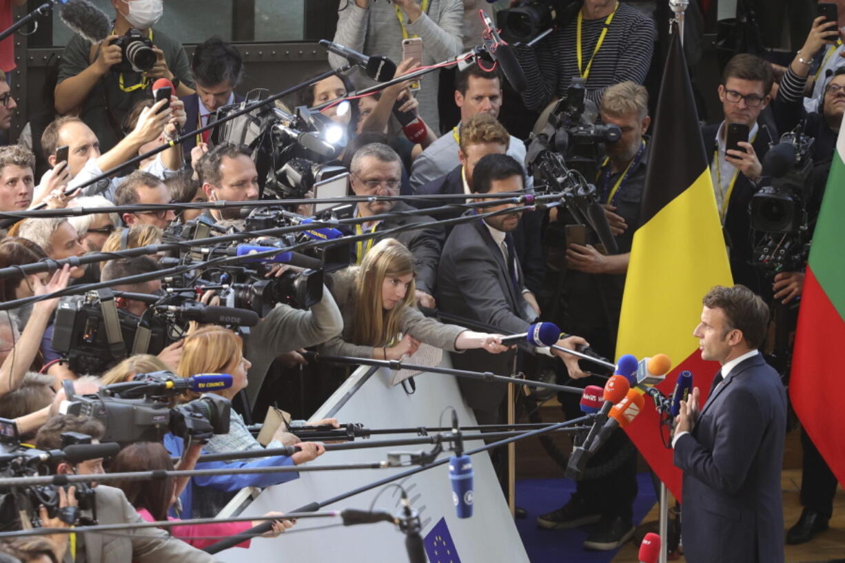 France's President Emmanuel Macron speaks with the media as he arrives for an EU summit at the EU Council building in Brussels, Thursday, Oct. 20, 2022. European Union leaders were heading into a two-day summit Thursday with opposing views on whether, and how, the bloc could impose a gas price cap to contain the energy crisis fueled by Russian President Vladimir Putin's invasion of Ukraine and his strategy to choke off gas supplies to the bloc at will.